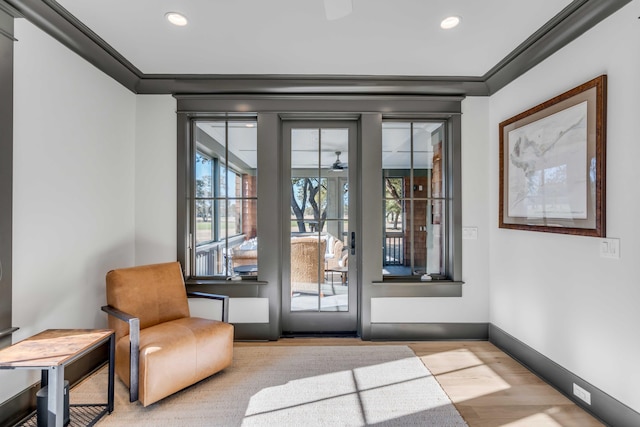 doorway with crown molding and light wood-type flooring