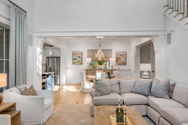 living room featuring an inviting chandelier and light wood-type flooring