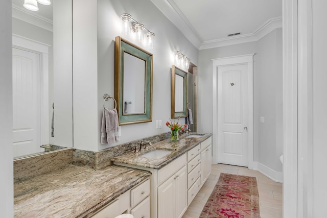 bathroom with vanity and ornamental molding