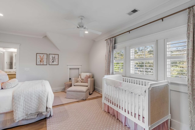 bedroom featuring multiple windows, hardwood / wood-style flooring, lofted ceiling, and ceiling fan