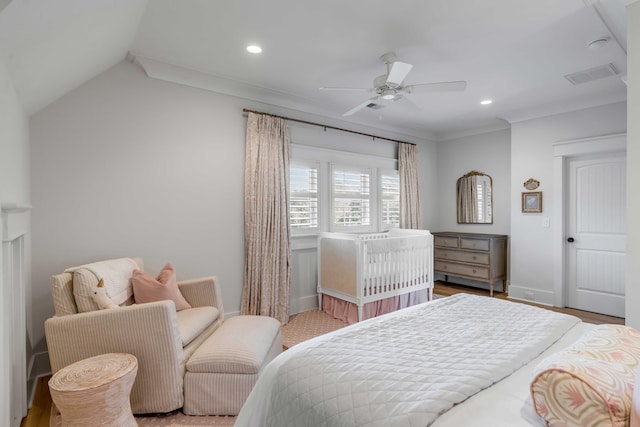 bedroom featuring lofted ceiling, ornamental molding, and ceiling fan