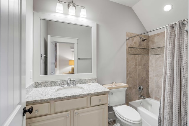 full bathroom featuring shower / bath combination with curtain, vanity, toilet, and vaulted ceiling