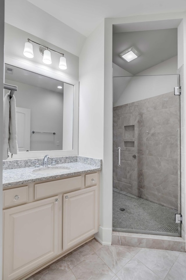 bathroom with vanity and a shower with door