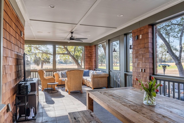 sunroom featuring a healthy amount of sunlight and ceiling fan