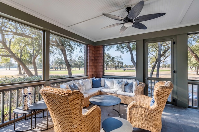 sunroom / solarium featuring a wealth of natural light and ceiling fan