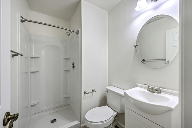 bathroom featuring a shower, toilet, and vanity