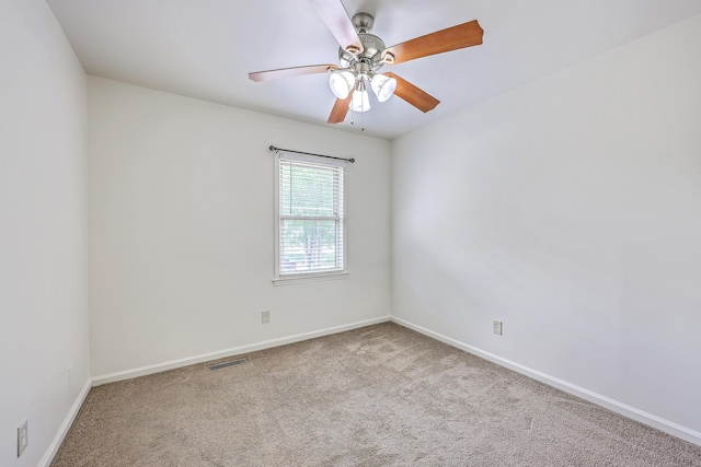 carpeted empty room featuring baseboards and ceiling fan