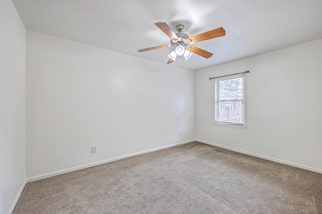 empty room with carpet, baseboards, and ceiling fan
