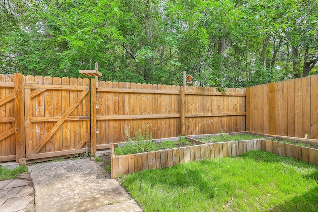 view of yard featuring a garden and a gate