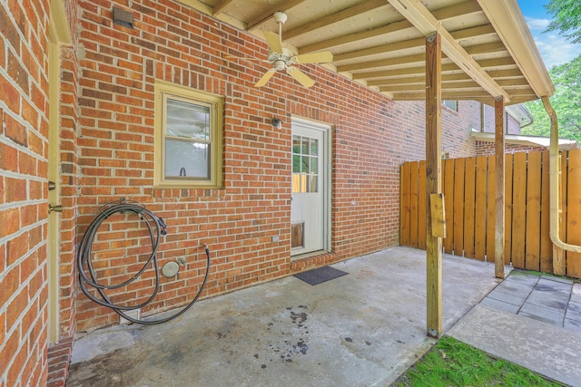 view of patio / terrace with a ceiling fan and fence