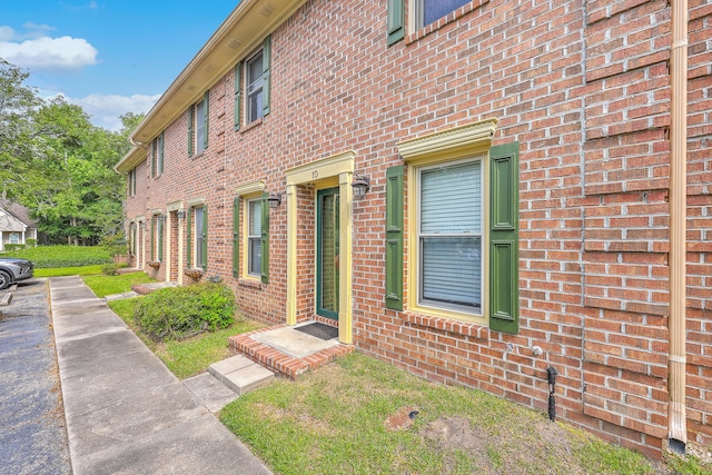 view of side of property featuring brick siding
