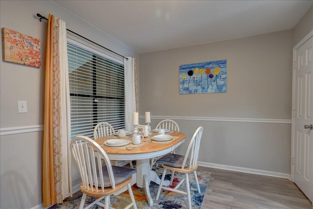 dining room with baseboards and wood finished floors