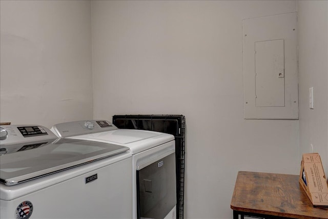 washroom with electric panel, laundry area, and washing machine and dryer