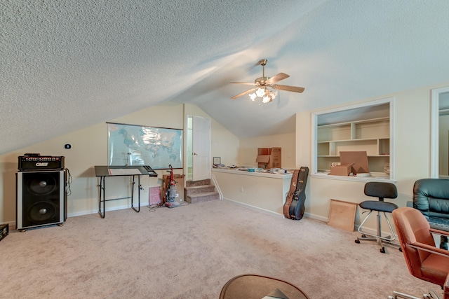 office featuring a textured ceiling, ceiling fan, carpet, and vaulted ceiling