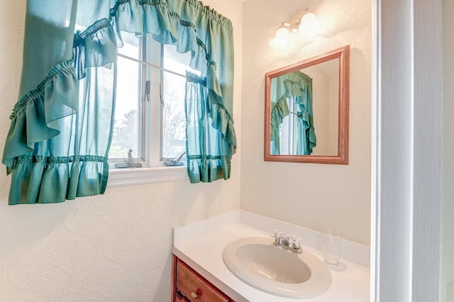 bathroom with vanity and a healthy amount of sunlight