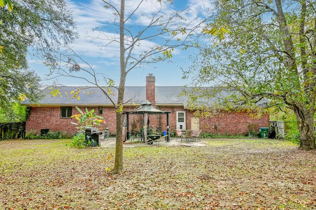 rear view of house with a gazebo and a patio area