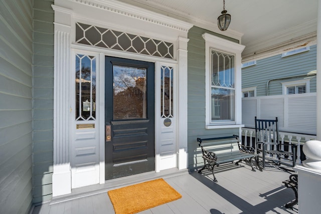 view of exterior entry with a porch