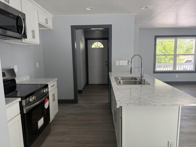 109 NW Haddock Rd, Orangeburg, SC 29115 - kitchen with stainless steel appliances, a sink, dark wood finished floors, recessed lighting, and white cabinetry