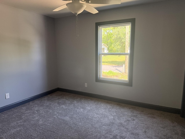 109 NW Haddock Rd, Orangeburg, SC 29115 - spare room with dark carpet, a ceiling fan, and baseboards
