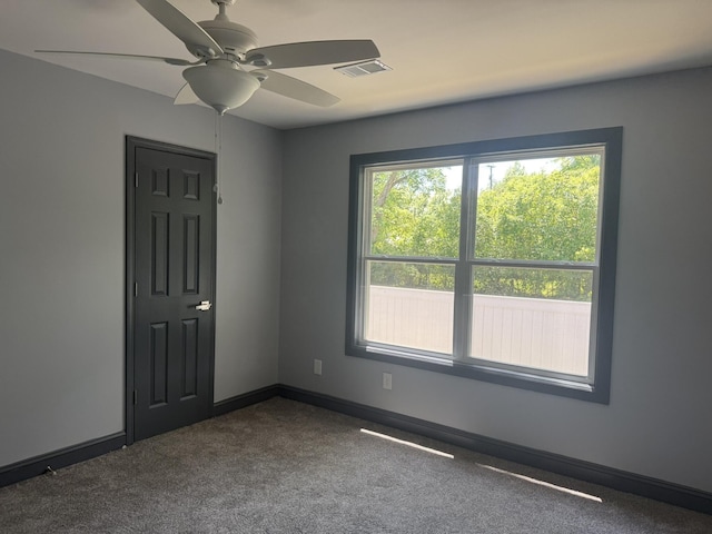 109 NW Haddock Rd, Orangeburg, SC 29115 - empty room with a ceiling fan, dark carpet, and baseboards