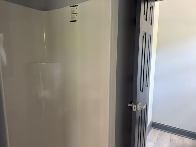 109 NW Haddock Rd, Orangeburg, SC 29115 - detailed view of water heater, wood finished floors, and baseboards