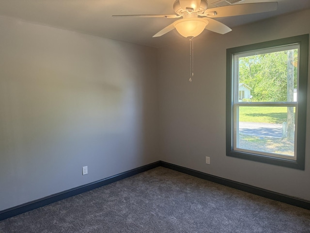 109 NW Haddock Rd, Orangeburg, SC 29115 - unfurnished room featuring dark colored carpet, a ceiling fan, and baseboards