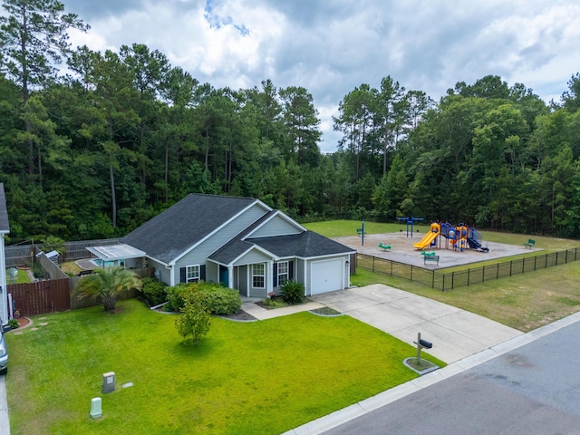 view of front facade featuring a playground, a garage, and a front yard