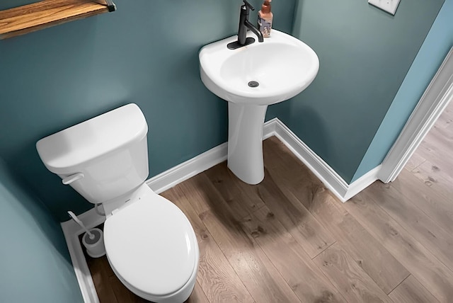 661 Black Pine Rd, Moncks Corner, SC 29461 - half bathroom featuring toilet, baseboards, and wood finished floors