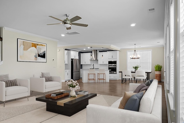 661 Black Pine Rd, Moncks Corner, SC 29461 - living room with crown molding, a chandelier, a ceiling fan, recessed lighting, and wood finished floors