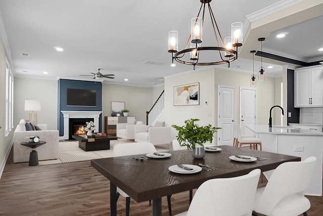 661 Black Pine Rd, Moncks Corner, SC 29461 - dining space with ornamental molding, ceiling fan, recessed lighting, wood finished floors, and a chandelier