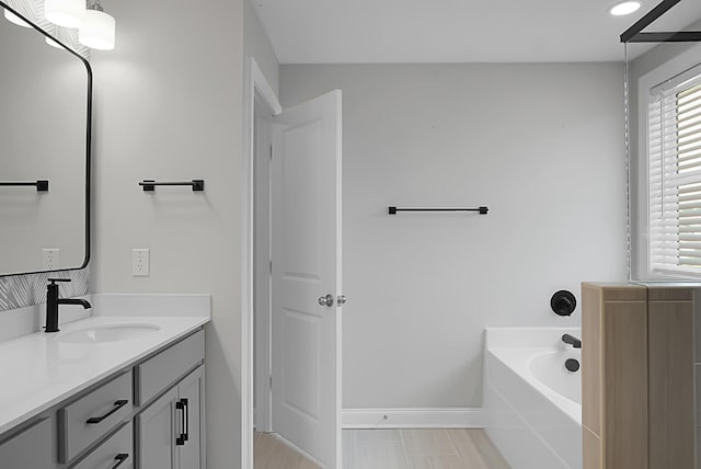 661 Black Pine Rd, Moncks Corner, SC 29461 - bathroom with vanity, a garden tub, healthy amount of natural light, baseboards, and recessed lighting