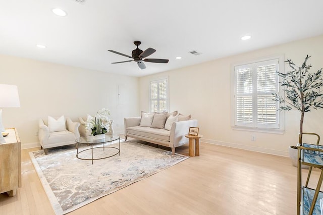 living room featuring ceiling fan and light hardwood / wood-style floors