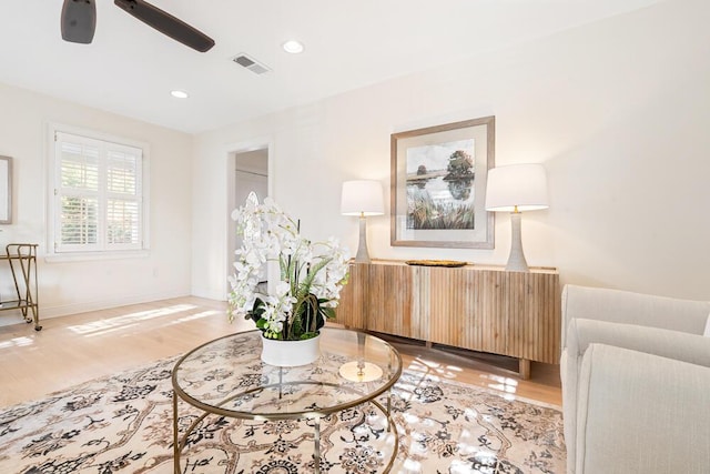 living area featuring ceiling fan and light hardwood / wood-style flooring