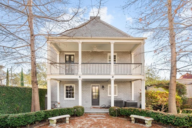 view of front of house featuring a balcony, a porch, and central air condition unit