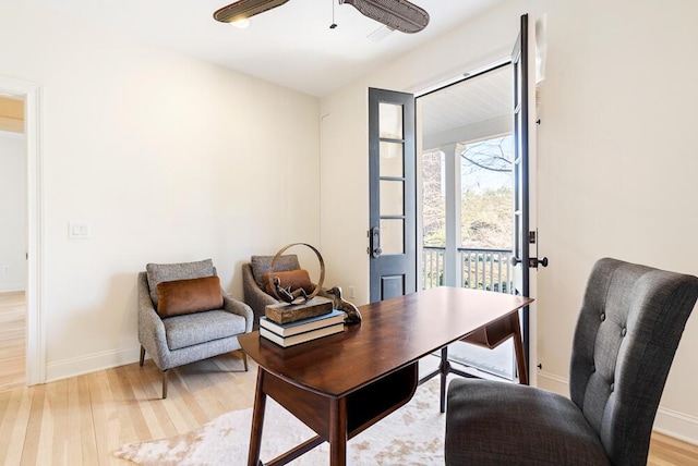 home office with ceiling fan and light hardwood / wood-style floors