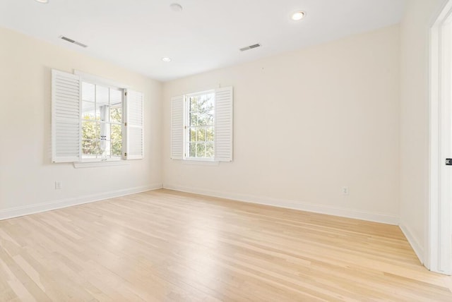 empty room with light hardwood / wood-style flooring