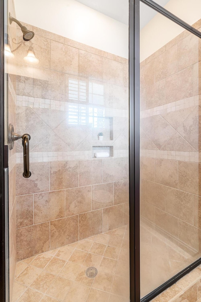 bathroom featuring a shower with shower door