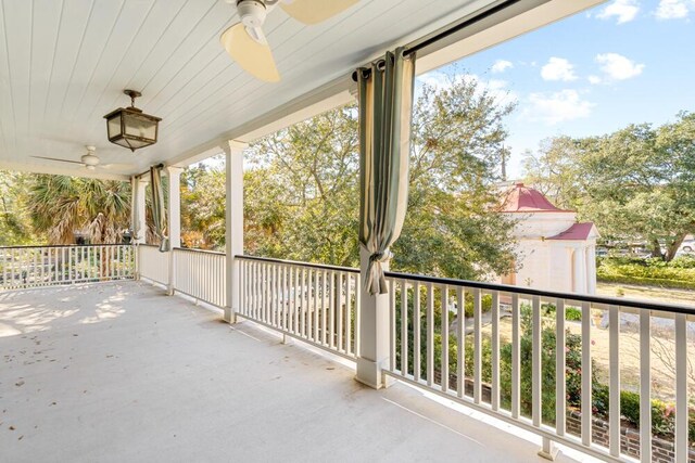 balcony featuring ceiling fan and a porch