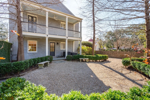 view of front of property with a balcony and central AC