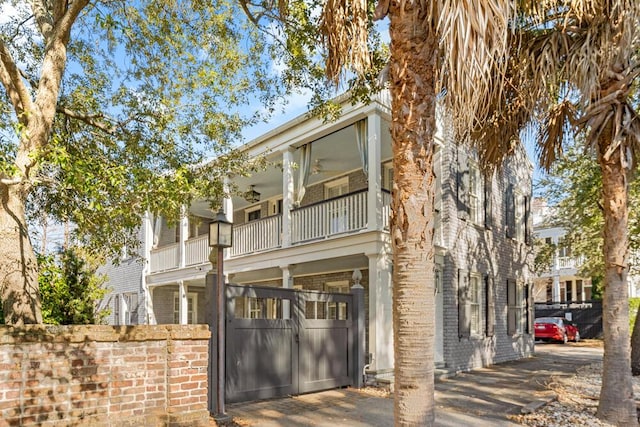 view of front of property with a balcony and ceiling fan