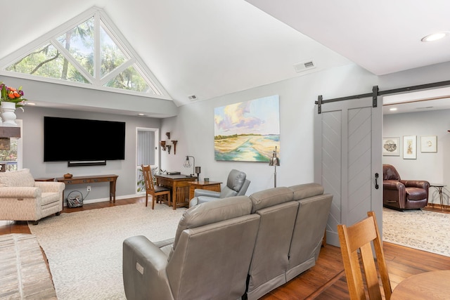 2500 The Bent Twig, Seabrook Island, SC 29455 - living area featuring a barn door, wood finished floors, healthy amount of natural light, recessed lighting, and high vaulted ceiling