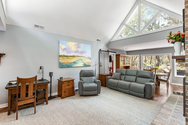 2500 The Bent Twig, Seabrook Island, SC 29455 - living area with a barn door, wood finished floors, baseboards, and high vaulted ceiling