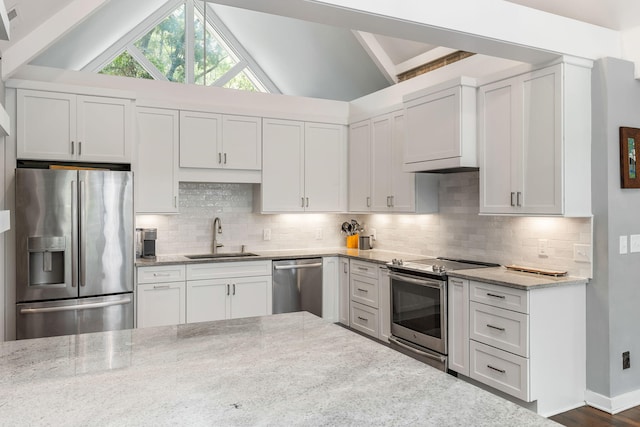 2500 The Bent Twig, Seabrook Island, SC 29455 - kitchen with appliances with stainless steel finishes, a sink, light stone counters, white cabinetry, and lofted ceiling