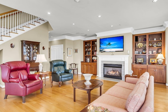 225 Seven Farms Dr Unit 307, Daniel Island, SC 29492 - living room featuring crown molding, light wood finished floors, recessed lighting, a glass covered fireplace, and stairs
