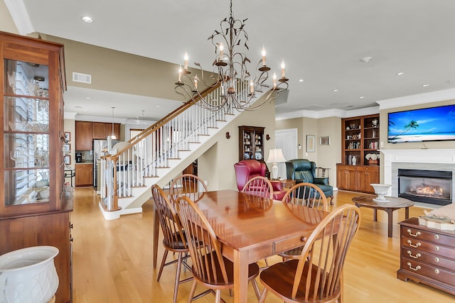 225 Seven Farms Dr Unit 307, Daniel Island, SC 29492 - dining area with light wood-type flooring, stairs, recessed lighting, crown molding, and a fireplace