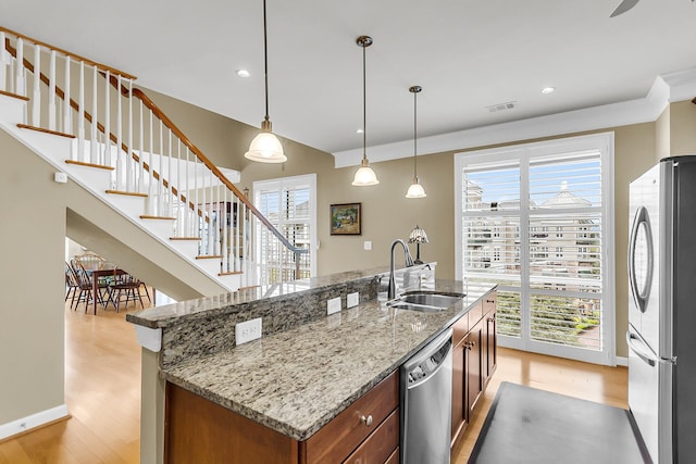 225 Seven Farms Dr Unit 307, Daniel Island, SC 29492 - kitchen with stainless steel appliances, light wood finished floors, plenty of natural light, and recessed lighting