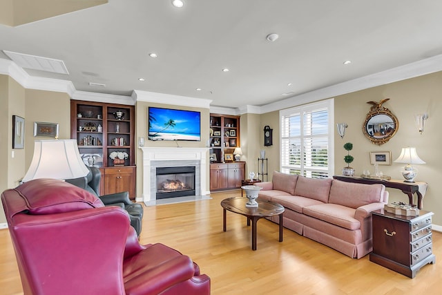 225 Seven Farms Dr Unit 307, Daniel Island, SC 29492 - living area with crown molding, light wood-type flooring, a fireplace with flush hearth, recessed lighting, and built in features