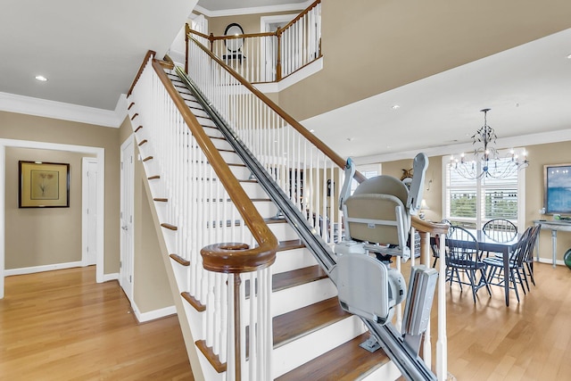 225 Seven Farms Dr Unit 307, Daniel Island, SC 29492 - stairway with wood finished floors, a chandelier, ornamental molding, and recessed lighting