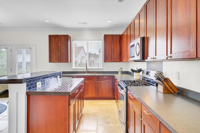 145 Woodbrook Way, Moncks Corner, SC 29461 - kitchen with appliances with stainless steel finishes, a sink, dark countertops, ornamental molding, and a kitchen island