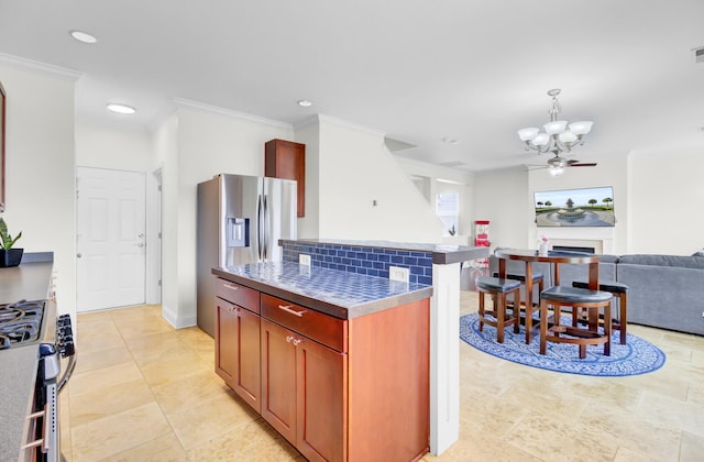 145 Woodbrook Way, Moncks Corner, SC 29461 - kitchen featuring gas stove, a chandelier, open floor plan, a kitchen island, and crown molding